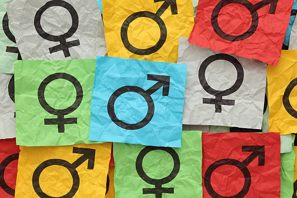 Close-up of gender symbols on colorful paper Crumpled colorful paper notes with gender symbols. gender symbol stock pictures, royalty-free photos & images