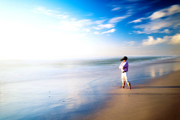 istock Man with gas mask standing on the beach 182153057