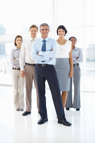 istock Team of business executives smiling in office 182153371