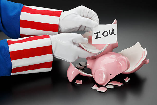 Government Debt Uncle Sam with a broken piggy bank and only an IOU to show for it. uncle sam broke stock pictures, royalty-free photos & images