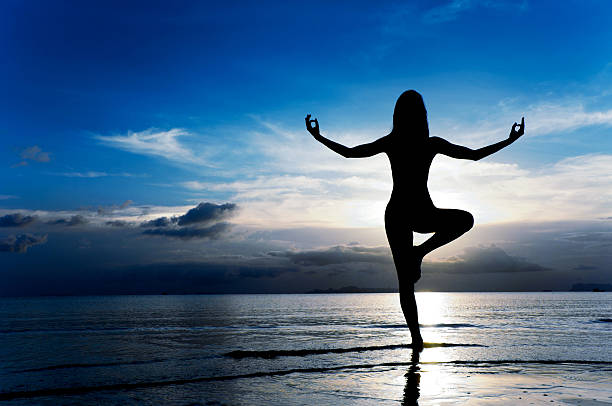 istock A person meditating on a beach during sunrise 182153741