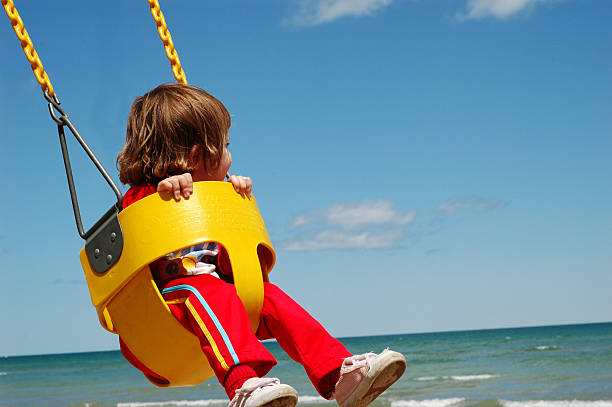 istock Girl Swinging by the Water 182153791