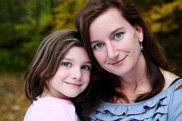 Beautiful Mother and Daughter Looking at Camera