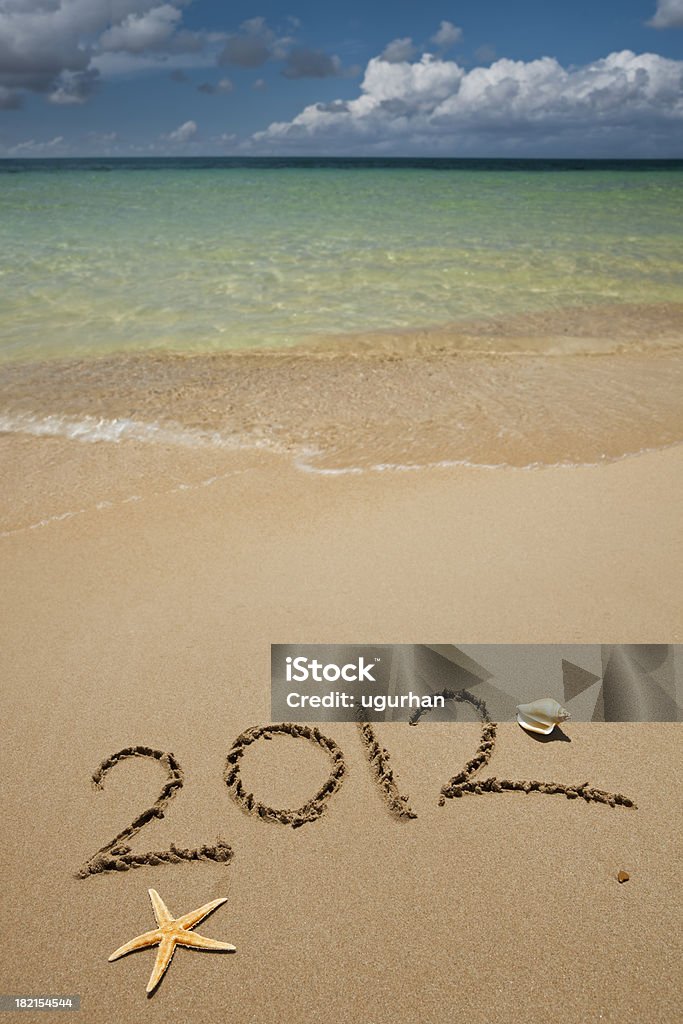 2012 written on the sand of a beautiful tropical beach. 2012 Stock Photo
