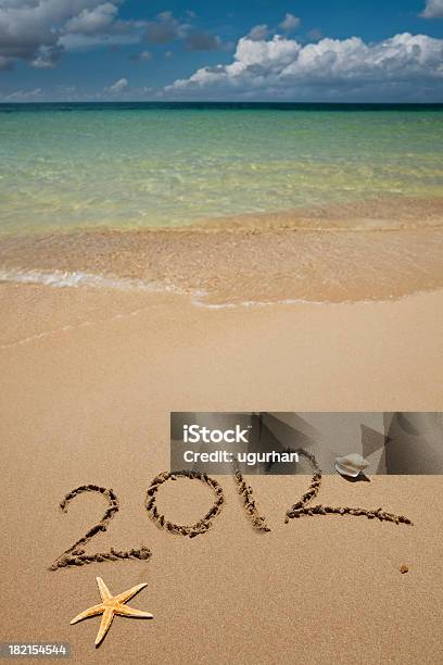 2012 Written On The Sand Of A Beautiful Tropical Beach Stock Photo - Download Image Now