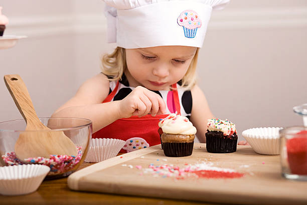 istock Cupcake Decorating by Little Girl Close Up Image 182155242