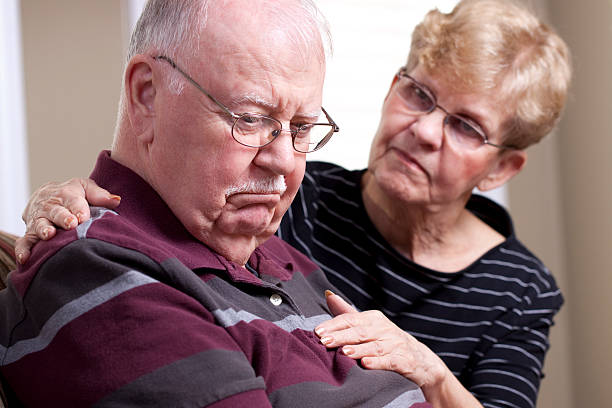 istock A senior man who is depressed and a concerned spouse  182155300