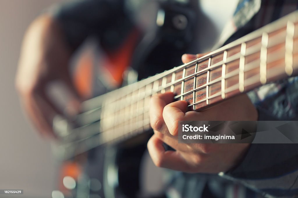 Playing Guitar Musician playing guitar. Bass Guitar Stock Photo