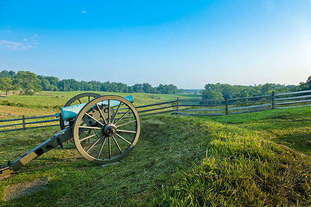 Cannon at the Gettysburg National Military Park American Civil War bronze cannon weathered with age to a pale greenish hue rests at  at Gettysburg National Military Park, Gettysburg, Pennsylvania, USA.  This picture was taken near the Eternal Light Peace Memorial. gettysburg national military park stock pictures, royalty-free photos & images