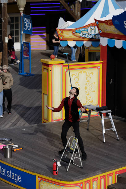 Pier 39 San Francisco California April 2023 Male Performer entertaining tourists an locals with his juggling, balancing and jokes.