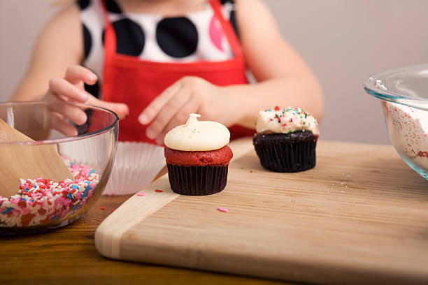 istock Cupcake Decorating by Little Girl Close Up Image 182156616