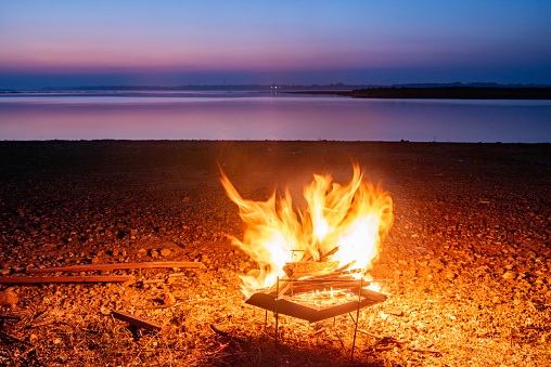 Bonfire by the lake in the evening