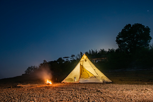 Pyramid tent and bonfire at night