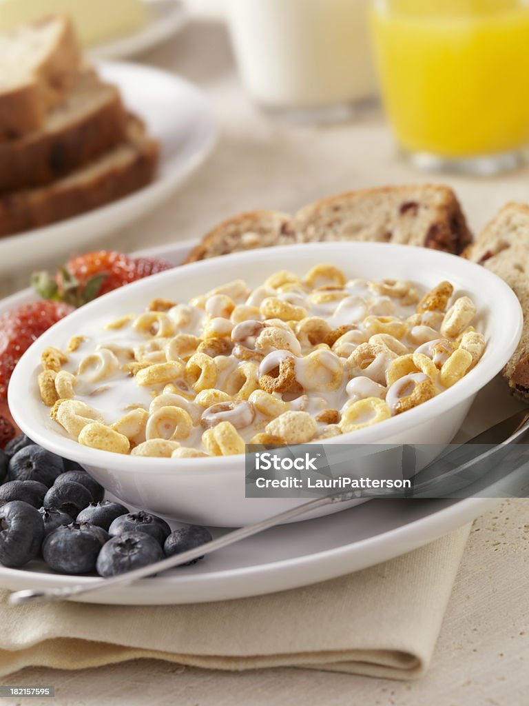 Toasted Oat Breakfast Cereal "Toasted Oat Breakfast Cereal with Fresh Fruit, Whole Grain Bread, Milk and Orange Juice- Photographed on Hasselblad H3D2-39mb Camera" American Culture Stock Photo