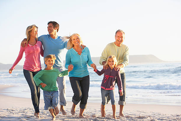 istock Three Generation Family On Holiday Running Along Beach 182157803