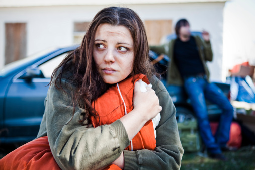 A stock photo of a woman and man living out of their car after loosing their home.