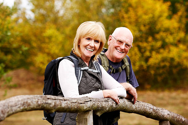 istock Happy senior hikers standing by a fence 182158375