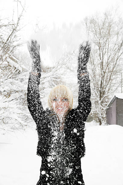 istock Woman playing with snow 182158430