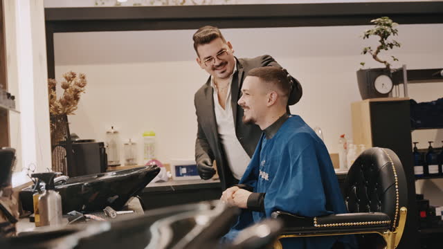 SLO MO Smiling Young Professional Barber and Customer Discussing Over Haircut in Barbershop