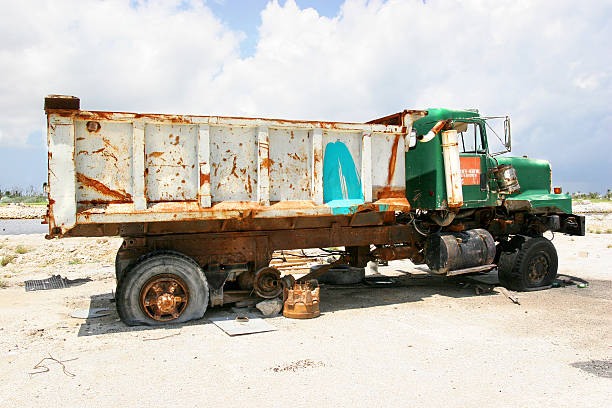 This is a old retro toy farm pick up truck with apples in the bed sitting on a wood table background.