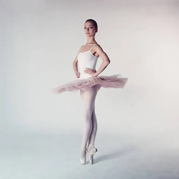 Professional ballerina in tutu posing in studio.