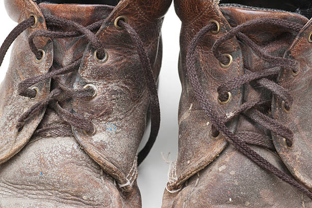 istock pair of well used, dirty work boots 182158658