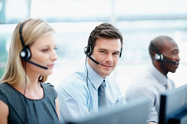 istock Customer service team wearing headsets in a call center 182158946
