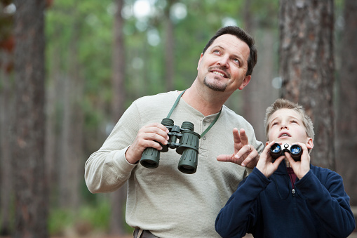 Father, 40s, and son, 11 years, enjoying nature