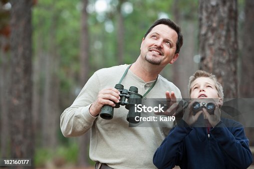 istock Father and son enjoying scenic view with binoculars 182160177