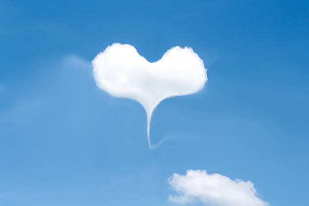 istock Clouds  on vast bright blue sky with heart shape patterns for design Valentine day or summer spring season love background and space 1821602611