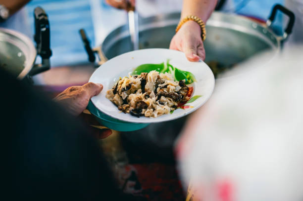 istock Feeding the poor to hands of a beggar. Poverty concept 1821606997