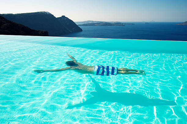 istock Man Swimming Underwater Infinity Pool Escape Santorini Greece 182160805