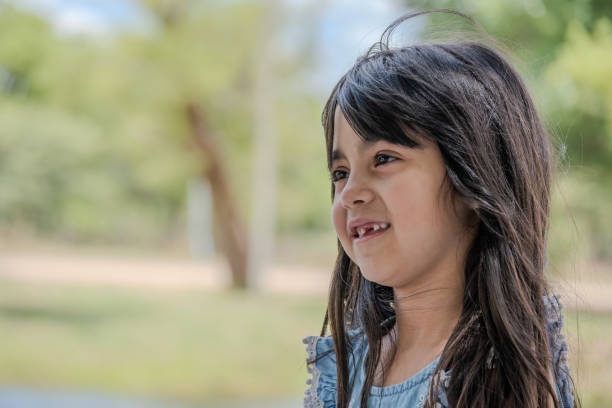 istock Beautiful little girl pictured in a park while talking. 1821610533