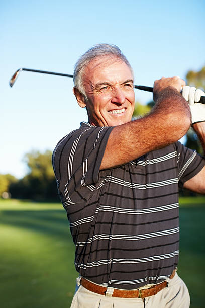 mature giocatore di golf - golf playing teeing off men foto e immagini stock