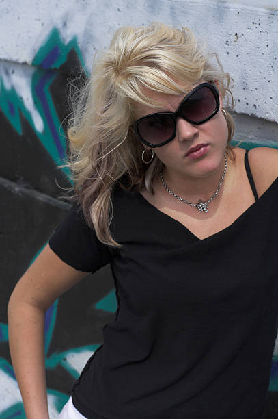 istock A blonde woman leaning against a wall 182162177