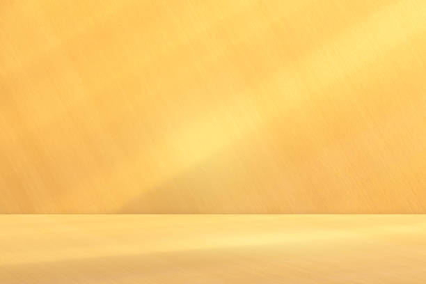 istock Elegant golden product display counter shelves Abstract backdrop and background inside empty studio with shadow and below the golden color there is a shadow Modern luxury merchandise shelves 1821627793