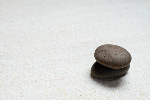 Top view, of stones placed on sand, concept japanese zen garden stone balance