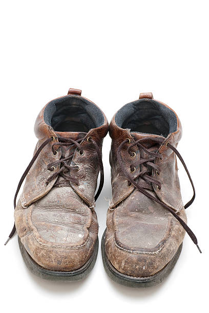 istock pair of well used, dirty work boots 182163367