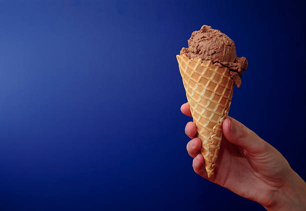 Cone de Gelado de Chocolate sobre azul com espaço para copiar - fotografia de stock