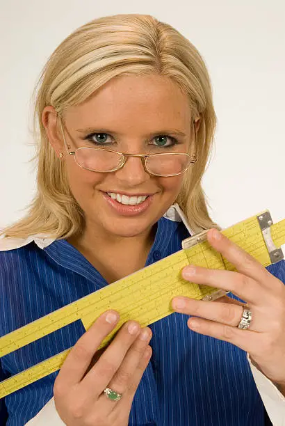 "Cute blonde engineer with her sliderule, glasses, and a great smile! Isolated on a white background."