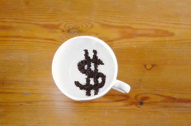 "Dollar symbol in tea-leaves in white tea-cup. Concept of predicting financial future, reading the stock market. Wooden background easily removed/replacedFor variations on this concept,with currency changes, please see this LB"