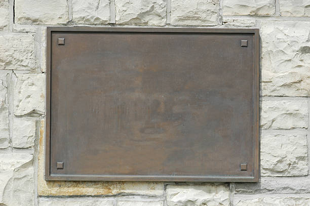 Bronze Memorial Plaque On Stone Wall Bronze plaque on stone wall. Add your own text or image. Clipping path included to isolate the sign from the wall. brass stock pictures, royalty-free photos & images