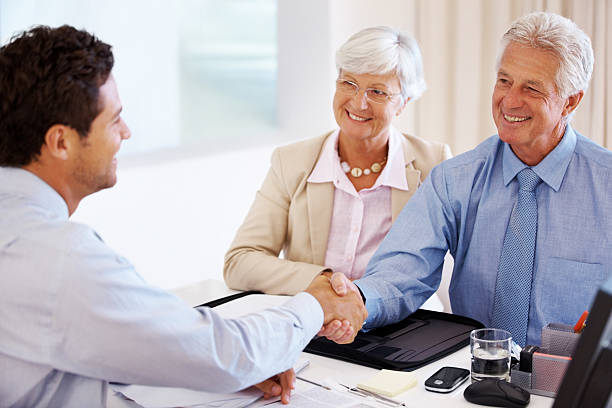 istock Senior couple meeting with a financial advisor 182165448