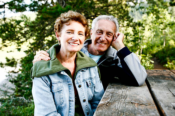 istock Beautiful senior couple sitting at a picnic table 182166018