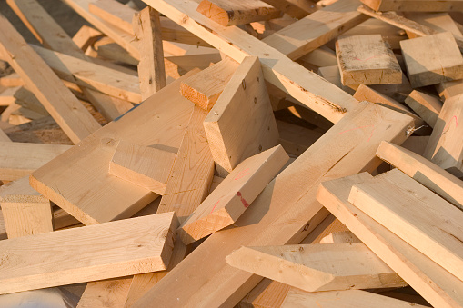 Pile of wooden lumber at construction site. Shot in sunsetting light. We have other construction images in our portfolio.