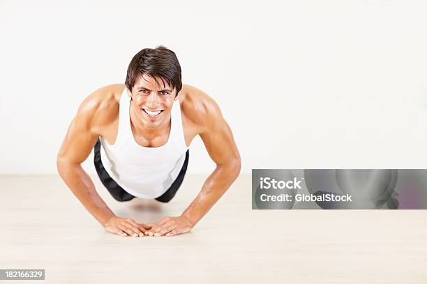 Happy Young Athletic Guy Doing Push Ups At A Gym Stock Photo - Download Image Now - 20-24 Years, Activity, Adult