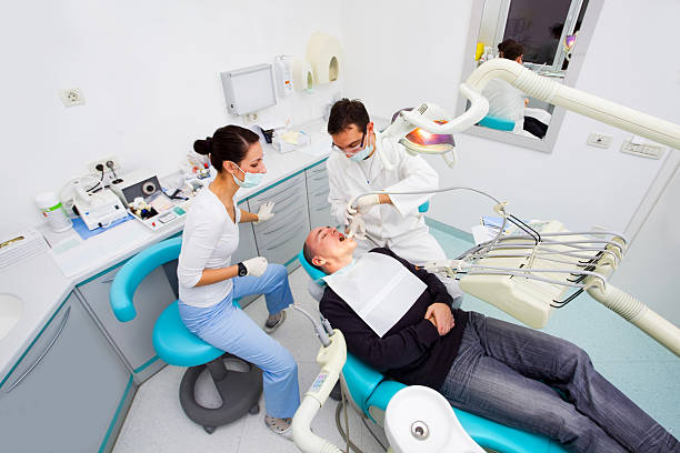 istock Dentist team and middle aged patient. 182166450