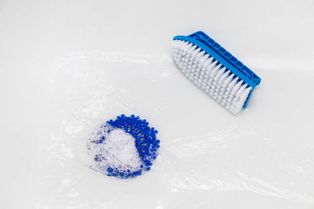 istock cleaning a white bathtub with a brush 1821665526