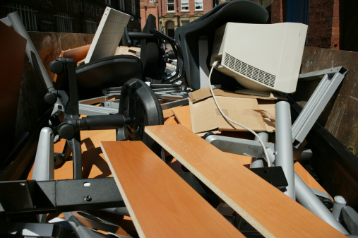 Skip from office clearout with outrageous wasted furniture and PC equipment