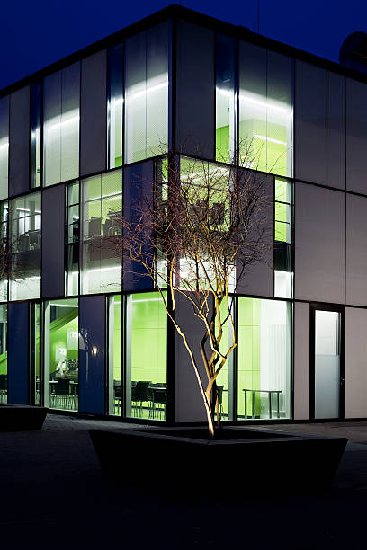 istock Office building - Architectural detail and illuminated tree 182167096